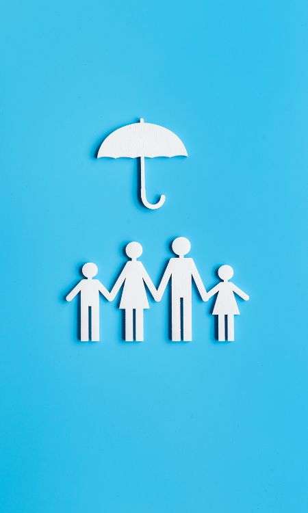 Wooden family figure under umbrella with space for text. Insurance concept