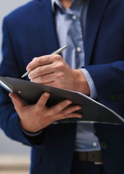 Real Estate Appraisal. Inspector with Folder Conducting Property Valuation at Home Closeup